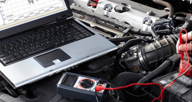 A diagnostics kit hooked up to a car engine