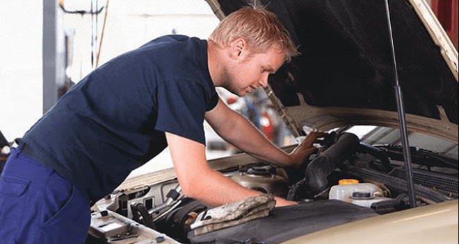 A mechanic working on a car