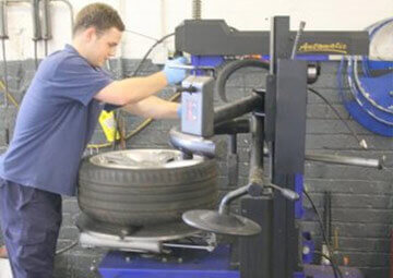 A mechanic working on a car